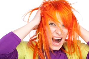 Shocked screaming woman holding red head with hands